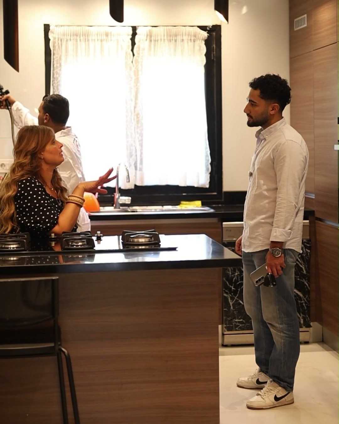 The team with the homeowners in the kitchen.